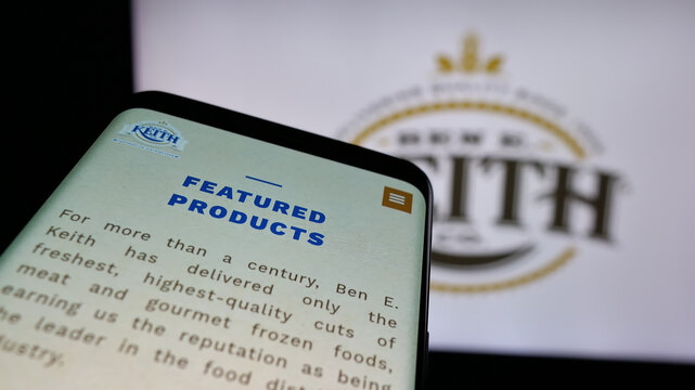 Stuttgart, Germany - 05-16-2025: Mobile phone with website of US distribution business Ben E. Keith Company on screen in front of logo. Focus on top-left of phone display.