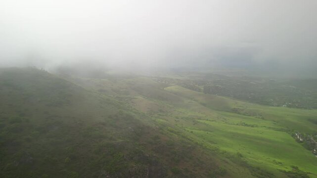 Aerial through low clouds above Ken Caryl Valley in Littleton Colorado in spring in foothills