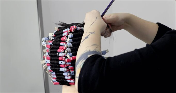 Perm training on a mannequin at the school of hairdressing.