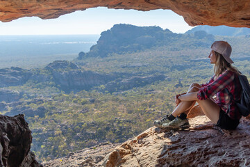 Solo Female Hiker Resting in Sandstone Cave in Grampians National Park, Victoria, Australia