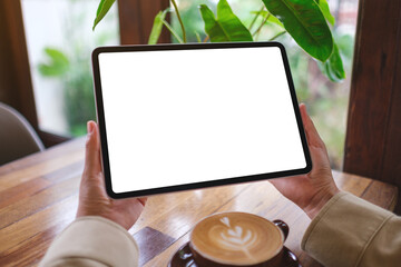 Mockup image of a woman holding digital tablet with blank white desktop screen