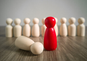  Wooden people figures on top of wooden blocks. Career growth, development and leadership