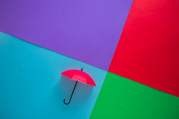 Red umbrellas hanging on a vivid multicolored background
