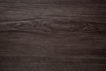 Obraz premium Dark brown wood grain texture background showing knots and growth rings