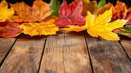 Obraz premium Vibrant Autumn Leaves on Rustic Wooden Surface