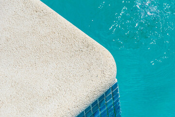 sunlit poolside abstract with turquoise water and tile textures, summer background concept