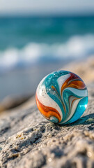 Glass marble with colorful swirl on stone