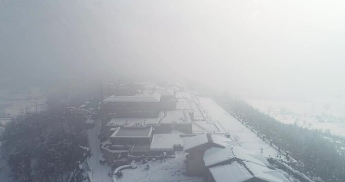 Aerial view of hazy srinagar city wrapped in snow