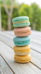 Stack of pastel macarons on wood surface