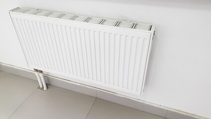 Heating radiator with regulator on the wall. Temperature regulator for home heating, space heating, home heating.