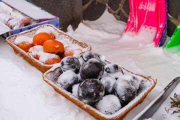 Snow covered persimmons and hot tea, food and snacks vendors at China Snow Town 