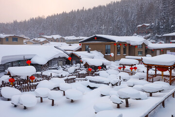 China snow town, mushroom houses covered by pure white snow in the mountain of a Chinese countryside 