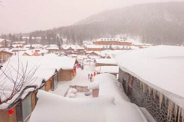 China snow town, mushroom houses covered by pure white snow in the mountain of a Chinese...