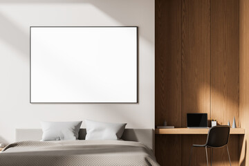 Modern minimalist bedroom interior with cozy bed, large blank frame on wall, and wooden workspace featuring laptop and chair in soft natural lighting. 3D Rendering