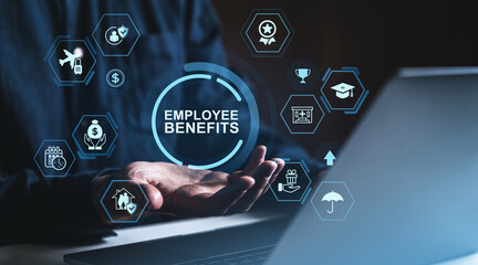 Employee benefits concept with icons displayed above open hands near laptop, representing workplace perks and services on dark blue background.