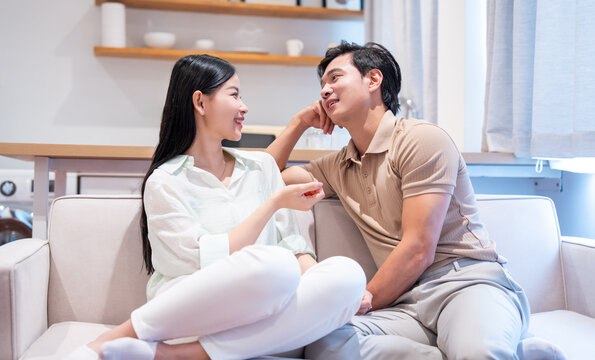 Couple shares intimate moment on couch in brightly lit living space fostering connection and conversation