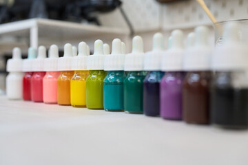 Colorful pigments in dropper bottles for candle making in craft studio