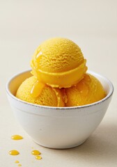 Three Scoops of Mango Ice Cream in a White Bowl