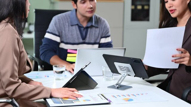Business team working with digital tablets and reports in a modern office. Concept of data analysis, teamwork, planning