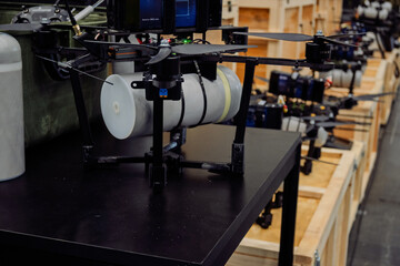 Fiber optic tethered drone with cable reel system on display at technology exhibition. Advanced UAV connected via optical fiber for secure data transmission.