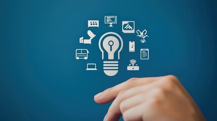 Fototapeta premium economy consumption efficiency concept. Light bulb icon surrounded by technology and business symbols with a hand pointing towards it.