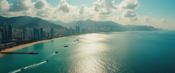 Obraz premium Coastal Cityscape with Turquoise Waters and Mountain Backdrop: Aerial View of Modern Architecture and Tranquil Seascape