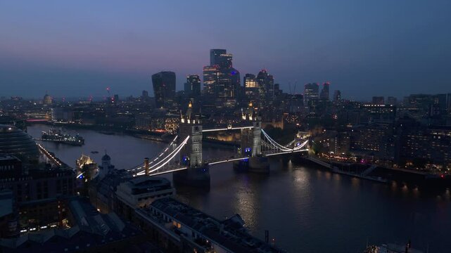 Embark on an adventure to discover and explore breathtaking twilight aerial shots that beautifully showcase the stunning Tower Bridge and the vibrant London skyline that lines the River Thames