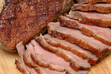 Perfectly fried duck breast, pink in the middle, a portion of meat cut into thin slices