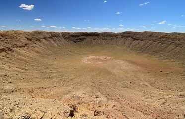 looking down from the crater rim at the spectacular  meteor crater natural landmark on a sunny summer day along  interstate 40 near winslow, in northern arizona