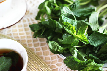 Black tea with mint and mint on the kitchen table