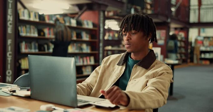Black man, student and laptop in library for studying, education or discomfort at school. Male person, adhd or academic learner with frustration on computer or chair for difficulty or distraction