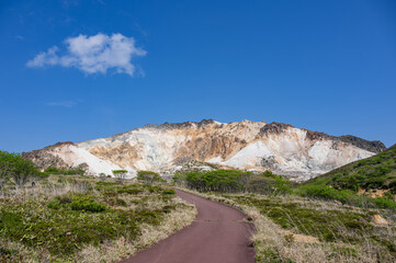 Blue sky and active volcano Mt.Esan with spewing smoke in Hakodate Hokkaido, Japan
