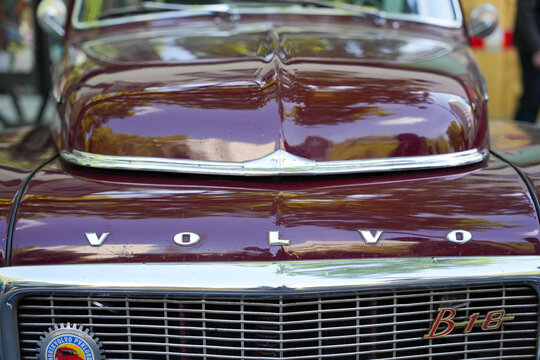 Germany Berlin May 11, 2025. The front of a dark red Volvo B18 with a chrome-plated grille and emblem. The glossy paint reflects its surroundings and emphasizes the classic lines.