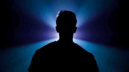 Silhouette of a person, illuminated by a spotlight