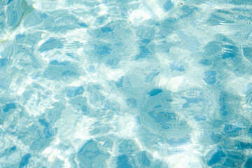 water surface waves texture, swimming pool exposed to the sun at summer