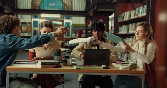 People, students or studying in library with group for learning, education or project at university. Academic, friends or team sharing information with documents or books for assignment at college