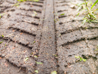 Detailed close-up capturing tire tread patterns on a dusty surface