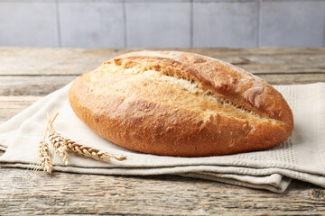 Loaf of bread and spikes on wooden table