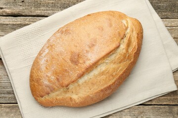 Loaf of bread on wooden table, top view
