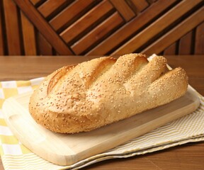 One fresh bread loaf on wooden table