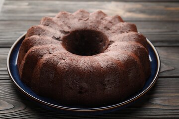 Tasty chocolate bundt cake on wooden table, closeup