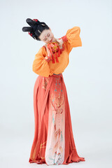 Beautiful dancers wearing ancient Tang Dynasty costumes and makeup performing classical dance