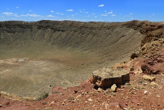 looking down from the crater rim at the spectacular  meteor crater natural landmark on a sunny summer day along  interstate 40 near winslow, in northern arizona