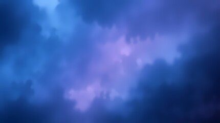 An abstract background featuring a gradient of blues and purples, resembling clouds or smoke, with soft edges and a blurred effect