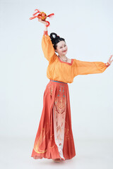 Beautiful dancers wearing ancient Tang Dynasty costumes and makeup performing classical dance