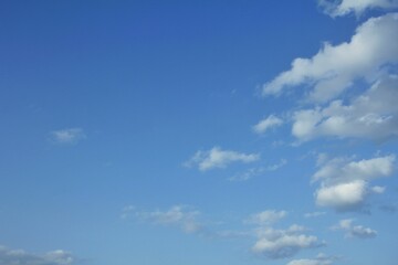 Bright Blue Sky with Wispy White Clouds on a Sunny Day, Perfect for Outdoor Activities and Clear Weather Imagery