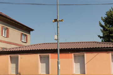 Outdoor emergency sirens mounted on tall poles, serving as a crucial part of an alert system designed for urban areas