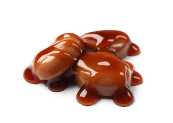 Tasty sweet candies and caramel sauce isolated on white