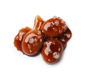 Tasty sweet candies, salt and caramel sauce isolated on white, top view