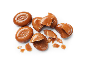 Broken tasty caramel candies isolated on white, top view